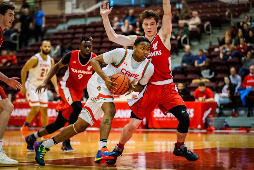 CJ Bennett of the Cape Breton Capers drives past Jason Thompson of the Memorial Sea-Hawks on his way to the basket during an Atlantic University Sport men’s basketball game Sunday at the Memorial Field House in St. John’s. The Sea-Hawks won 82-69, following a 64-58 Cape Breton win Saturday night. — Ally Wragg/Memorial Athletics photo