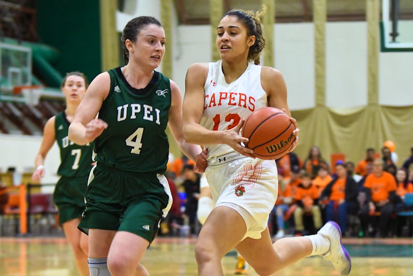 Hailey MacLeod, right, of Marion Bridge, drives past Prince Edward Island defender Jenna Mae Ellsworth during the Cape Breton Capers 62-57 loss to the Panthers on Saturday at CBU’s Sullivan Fieldhouse. MacLeod came off the bench to score six points and grab five rebounds during her 16 minutes of play. Meanwhile, the Capers men defeated the P.E.I. Panthers 76-66.