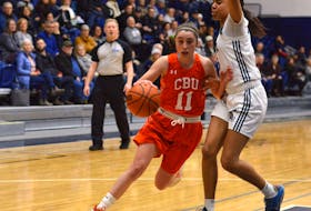 MacKenzee Ryan of the Cape Breton Capers, left, drives the lane during Atlantic University Sport women's basketball action against the St. Francis Xavier X-Women at Coach K Court in Antigonish on Friday. Cape Breton won the game 79-70. PHOTO/Paul Hurford, STFX Athletics.