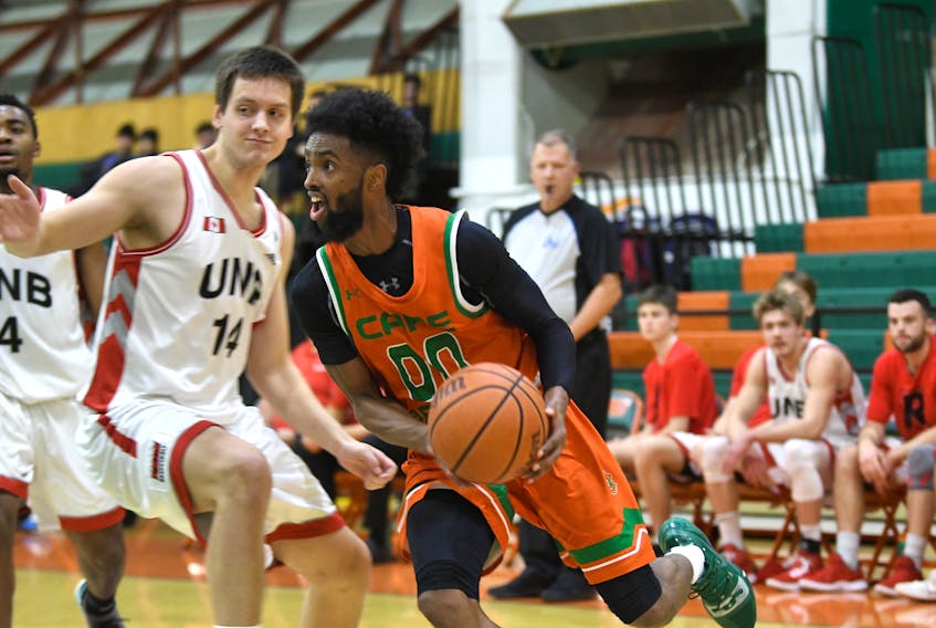 Cape Breton Capers Osman Omar drives to the hoop during Saturday action against the New Brunswick Reds. Omar led the Capers to an 86-85 overtime win over the Reds at CBU's Sullivan Fieldhouse to avenge Friday's heavy 97-56 loss to the same team. (Vaughan Merchant photo)