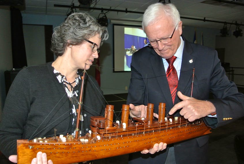 Amherst and Area Chamber of Commerce president Carys Wood and MP Bill Casey look over a model of the SS Kaiser Wilheim der Grosse that is being restored by Casey’s nephew, Matthew, and was the inspiration for a celebration in July that will mark the 100th anniversary of the closing of the Amherst internment camp in 1919.