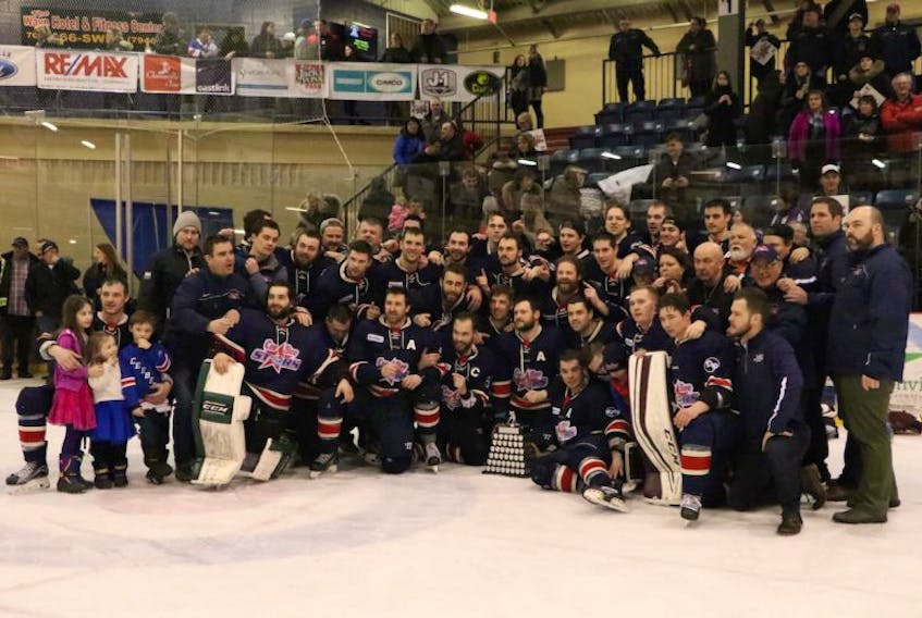 In this April 2, 2017 file photo, members of the Harbour Grace Ocean Enterprises CeeBee Stars gather around the Herder Memorial Trophy following a deciding 4-3 victory over the CWSHL champion Clarenville Caribous in Game 5 of the provincial senior hockey championship in Clarenville. Less than seven months after been winning the Herder, the CeeBees find themselves without a league, meaning they won't operate in 2017-18.