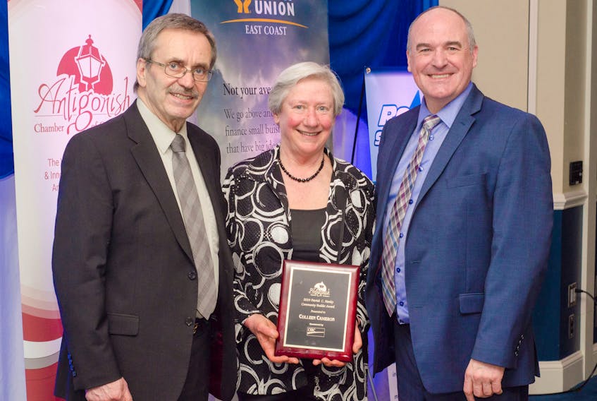Antigonish Chamber of Commerce president Dan Fougere (left) and David MacGillivray, the grandson of Patrick C. Hanley, present Colleen Cameron with the CIBC sponsored Patrick C. Hanley Community Builder Award, during the Chamber's President’s Dinner April 24.