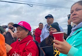 Sipekne’katik Chief Mike Sack (hat and grey sweater) stands with his community members in New Edinburgh, Digby County on Oct. 14, as unrest continued in an ongoing lobster dispute.