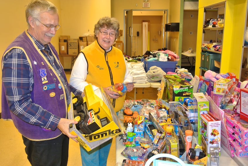 Phil Baxter from the Amherst Lions Club and Christmas for Kids longtime volunteer Joan Fowler look over some of the toys that have been put in place for the 24th edition of the program that aims to make sure every child has a gift under the tree on Christmas morning.