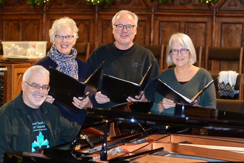Taking a break from decorating the Trinity-St. Stephen’s United Church for the Christmas season, and from ‘A Child’s Christmas in Wales’ rehearsals, are church choir members: (from left) music director Jeff Joudrey, and choir members Carol Baldock, Bruce Baxter and Wanda McSorely.