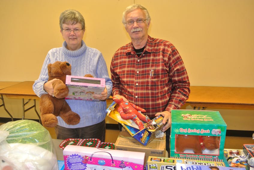 Amherst Lions Barbara and Phil Baxter look over some of the toys located at the Christmas for Kids centre in the Amherst Centre Mall. As the program heads into the final stretch the number of referrals is below previous years.