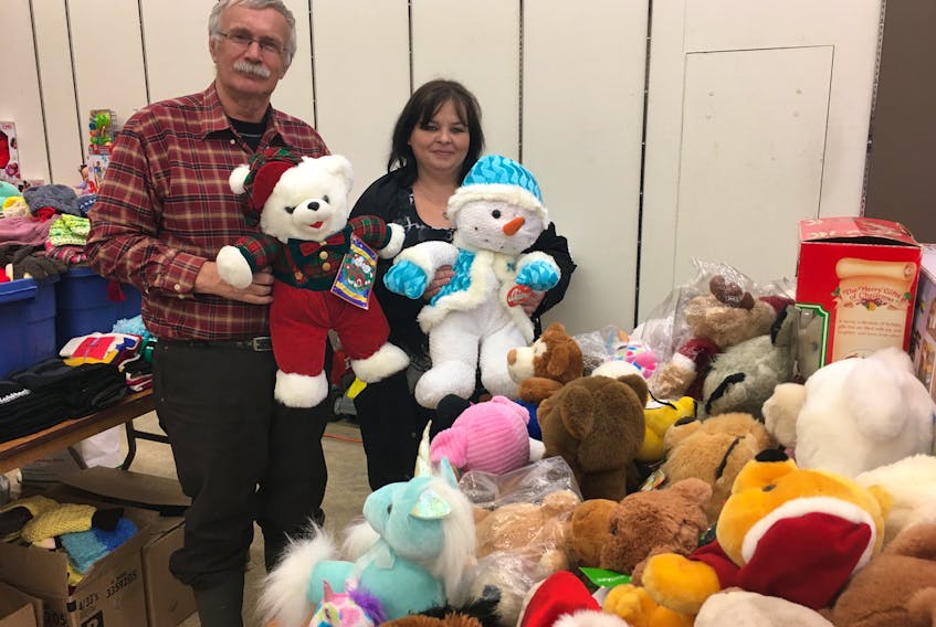 Phil Baxter and Julie Hicks look over some of the toys that have been collected for the Christmas for Kids program that is wrapping up for another year. This year there have been 535 referrals, down from 570 in 2018.