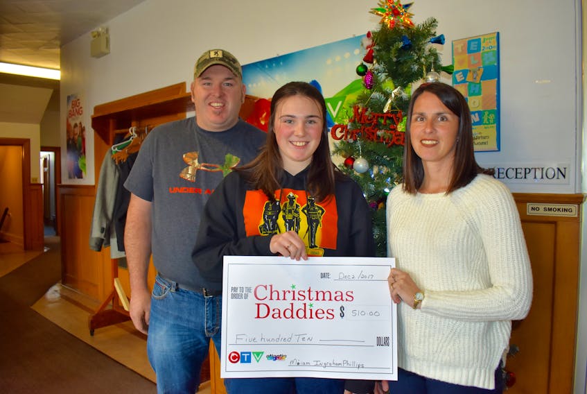 Miriam IngrahamPhillips, middle, stands with her parents, Elvis and Jody IngrahamPhillips, during the annual Christmas Daddies Telethon at the CTV studio in Sydney. Miriam, a Margaree Centre native, raised $510 as part of her commitment to Camp Courage, a camp that introduces young women to careers as first responders. She raised the money through sponsorship and donations as part of a 100-kilomentre bike ride she completed during the summer.