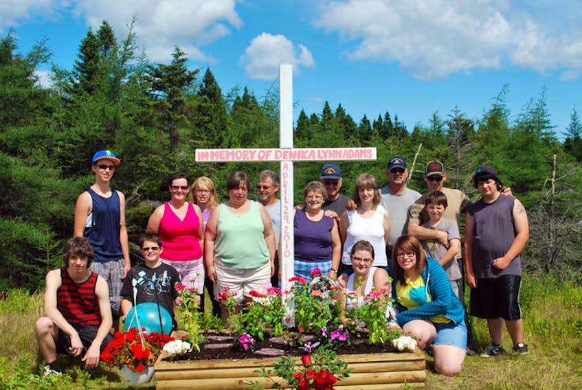 A group of family and friends at the site of Denika Adam's highway memorial. CONTRIBUTED