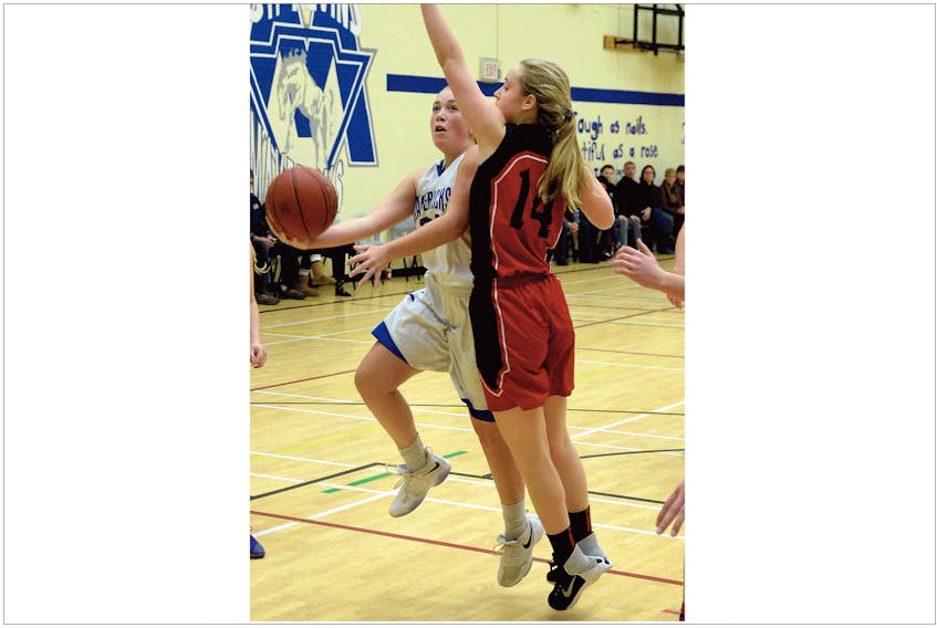 Keith Gosse/The Telegram—The St. Kevin's Maverick's Alyssa Maloney goes up for a shot against Erika McShane of the Waterford Valley Warriors during the final of the ninth annual Clarence Sutton Memorial basketball tournament at St. Kevin’s High School Sunday. The Host Mavericks won 63-53.