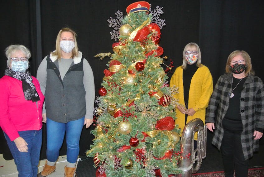 Members of Parrsboro’s Claus Cause (from left) Barb Amon, Jess Wheaton, Donna Yorke and Janice McLellan stand by the Christmas tree inside the Parrsboro Band Hall. The Claus Cause has worked over the last four years to decorate the downtown area of Parrsboro and spruce it up for the festive season.