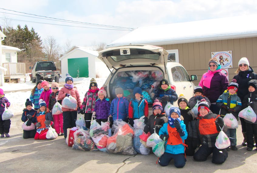 After-schoolers from the Children’s Place Learning Centre in Antigonish, along with centre personnel, gather just outside the centre before making the trek to deliver the clothes they gathered in their month-long clothing drive to the Opportunity Shop.