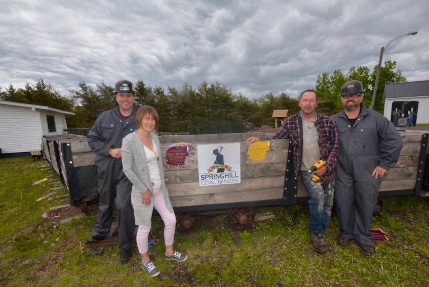 Springhill’s Miners Museum is getting a facelift and (from left) Tony Dowe, Roberta McMasters, Roy McMasters and Tony Somers installed the first round of memorial plaques on the refurbished coal carts in front of the museum.