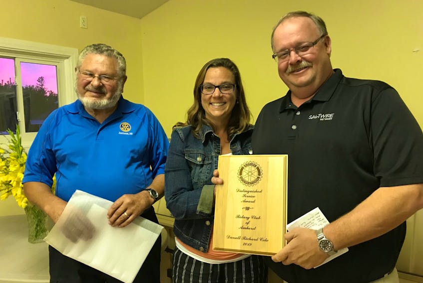 Amherst Rotarian Morris Haugg (left) and club president Trina Clarke present the Amherst Rotary Club’s Distinguished Service Award to Darrell Cole during the club’s annual lobster dinner on Sept. 6. Pam Harrison photo
