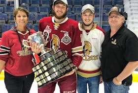 Cole Rafuse, second from left, holding the Memorial Cup with his parents and brother post-game on the ice at the Brandt Centre in Regina, Sask.