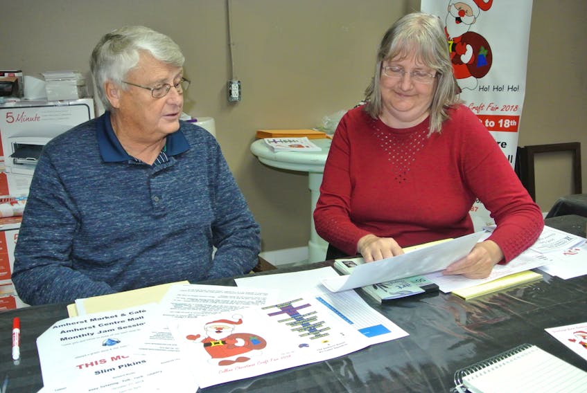 John Warner from the Amherst Artisans Gallery and Lisa Emery from CFTA Tantramar Community Radio look over plans for the first Collins Christmas Craft Fair at the Amherst Centre Mall from Nov. 16 to 18.