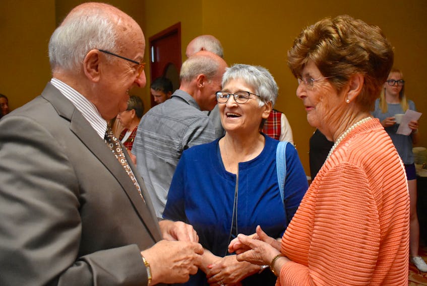 Nova Scotia Lieutenant Governor Arthur LeBlanc, left, chats with Paulette MacDougall, centre, and Joyce McKenzie following Sunday’s presentation of the Community Spirit Award to Glace Bay during a noon-time ceremony at the historic Savoy Theatre. - David Jala