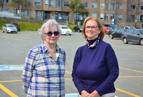 Fran Payne and Jeanne Cruikshank, stand in the Cunard lot on Lower Water Street in Halifax, the site of a proposed a 16-storey building multi-use building. Behind them and across the street is Waterfront Place, the building in which they both own condos.