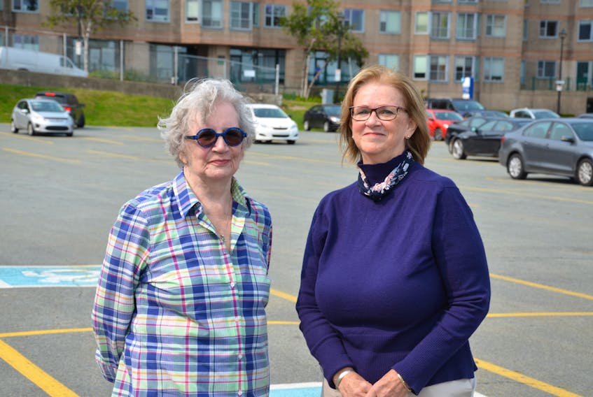 Fran Payne and Jeanne Cruikshank, stand in the Cunard lot on Lower Water Street in Halifax, the site of a proposed a 16-storey building multi-use building. Behind them and across the street is Waterfront Place, the building in which they both own condos.