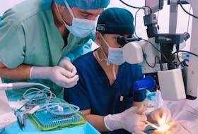 Dr. Justin French assists a student during a procedure in Mongolia. CONTRIBUTED