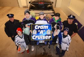 Amherst Peewee AAA Ramblers hockey players loaded the back of this pickup truck with food, and then unloaded it at the Amherst Food Bank. Players helping Const. Tom Wood, left, and Const. Tim Hunter with the Amherst Police Department’s 2018 Cram-A-Cruiser campaign are: (from left) Sawyer Harvey, Kieran Sears, Lucas Hurley, Phoenix Remington and Connor Hunter.