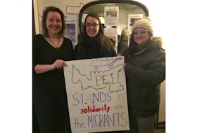 Showing support for caravan workers at a solidarity gathering Thursday in Charlottetown are, from left, Alanna Stewart, Ryanne Beatty and Lesley MacLean.
