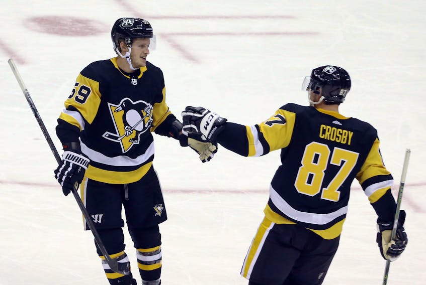 Pittsburgh Penguins winger Jake Guentzel (59) celebrates his goal with Sidney Crosby (87) against the New York Rangers during the third period at the PPG Paints Arena in Pittsburgh. The goal was the the 100th career NHL goal for Guentzel. The Penguins won 3-2. - Charles LeClaire / USA Today Sports