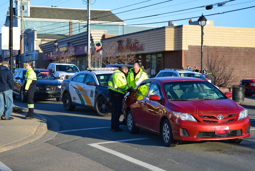 Cape Breton Regional Police investigate a vehicle-pedestrian accident on Commercial Street in Glace Bay, Friday morning. One woman was taken to the Cape Breton Regional Hospital in Sydney with undetermined injuries. SHARON MONTGOMERY-DUPE/CAPE BRETON POST