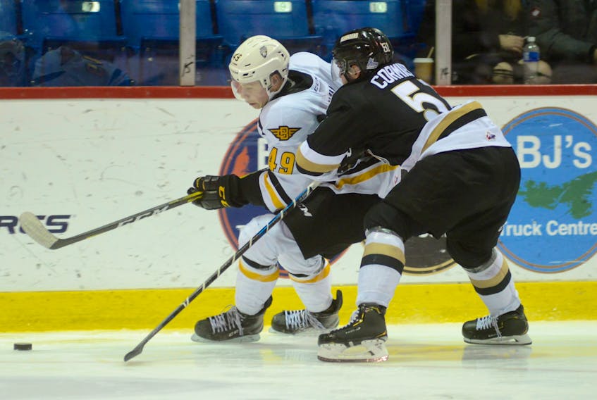 Cape Breton Screaming Eagles rookie Czech forward Ivan Ivan, left, is closely checked by Charlottetown Islanders defenceman Lukas Cormier during Québec Major Junior Hockey League action in Charlottetown, P.E.I. on Saturday. The hosts delighted the partisan Eastlink Centre crowd of 2,487 by earning a 3-2 overtime victory over the Eagles.