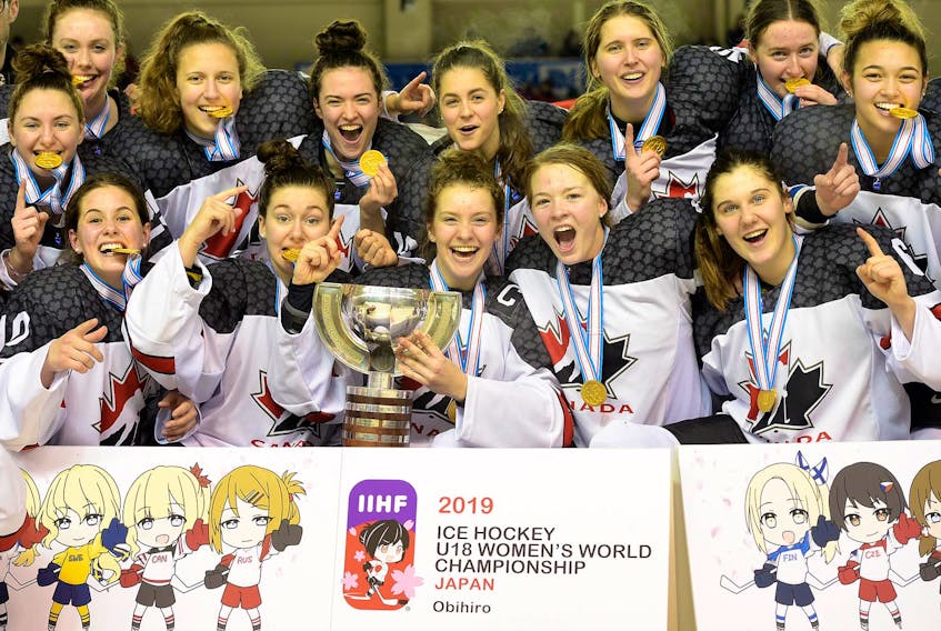 Team Canada, including Newfoundland and Labrador's Shailynn Snow (far left, second row) celebrate after defeating the United States 3-2 in overtime in the final of the world under-18 women's hockey championship Sunday in Obihiro, Japan. — Steve Kingsman/HHOF/IIHF Images
