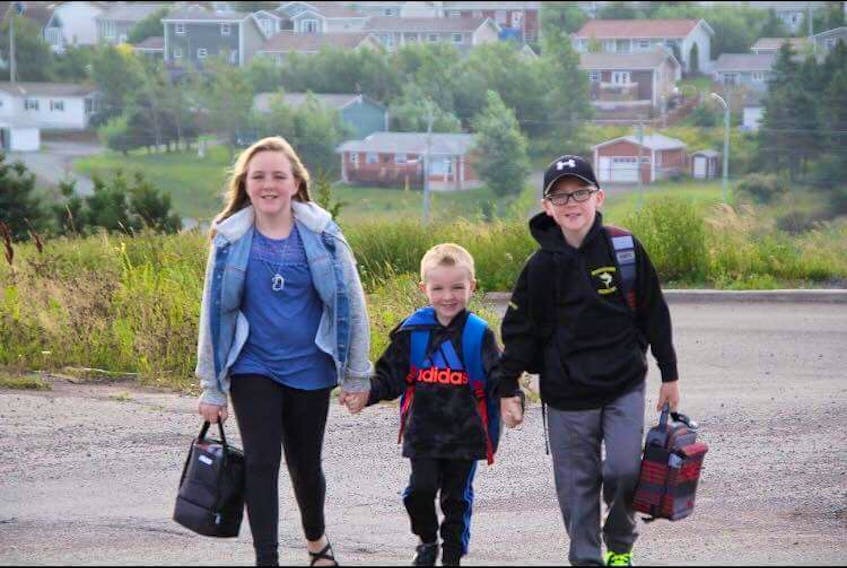 Starr Smith hopes to raise awareness of the concerns of parents over bussing by holding a walk on Monday, Sept 10. From the left in Maria Smith, Jackson Smith and Christpher Smith Walking to school.