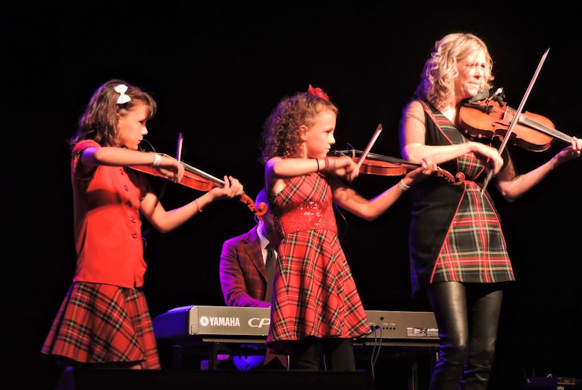 Proud mom Natalie MacMaster performs with daughters Claire and Julia at the opening night concert for the 2018 Celtic Colours International Festival on Friday at the Port Hawkesbury Civic Centre. The event continues at venues all over Cape Breton Island until Saturday, Oct. 13.