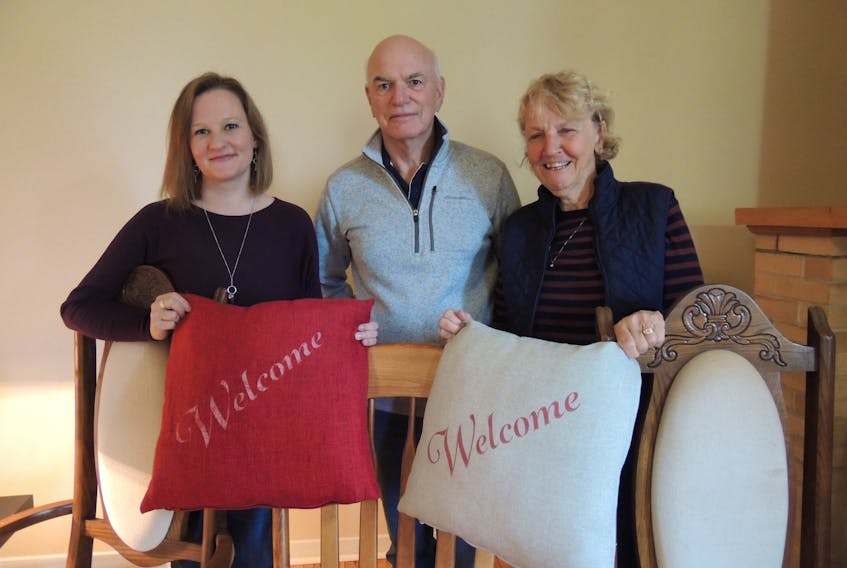 Sarah MacIntosh Wiseman, Dave Hanley and Cathy Hanley assembling furnishings to provide a home for the first of seven Syrian families being resettled in Pictou County this month.