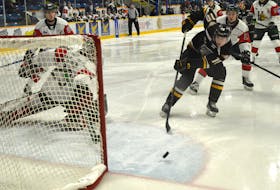 Connor Trenholm of the Cape Breton Eagles, middle, chips a puck shy of the empty net as Halifax Mooseheads netminder Cole McLaren attempts to make the save during Quebec Major Junior Hockey League action at Centre 200 on Friday. Cape Breton won the game 5-3. JEREMY FRASER/CAPE BRETON POST