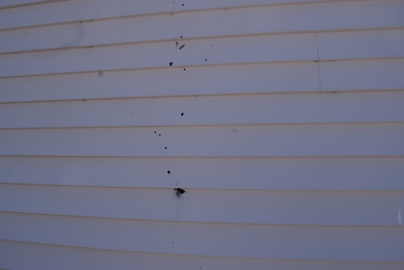 A vertical pattern of bullet holes and possible shrapnel can be seen on one wall of the Onslow Belmont Fire Hall. - Harry Sullivan
