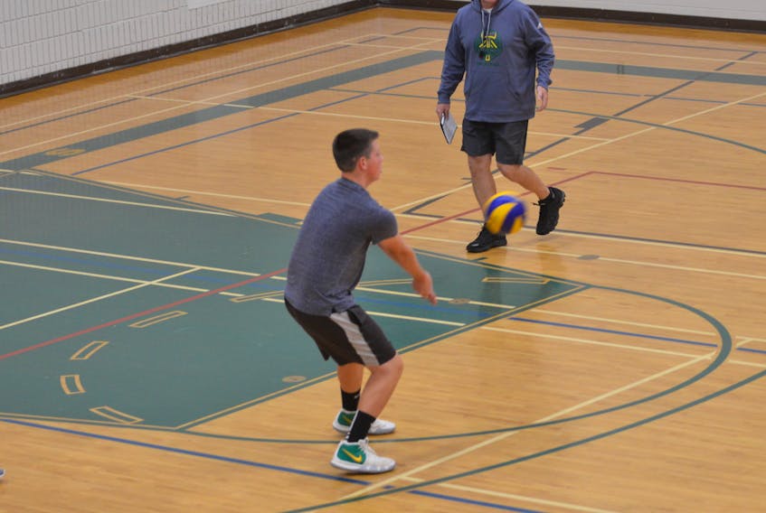 Head coach Dale MacDougall watches closely as Connor Lilly makes a play on the ball during a recent practice for the Three Oaks Axemen senior AAA boys’ volleyball team.