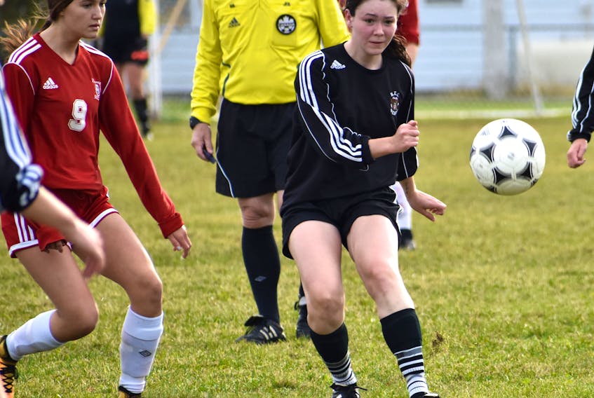 Madison Bresowar of the Breton Education Centre Bears, right, kicks the ball as Ella Binder of the Riverview Reds pressures during Cape Breton High School Soccer League girls action at Riverview High School in Coxheath on Thursday. Riverview won the game 3-2.
