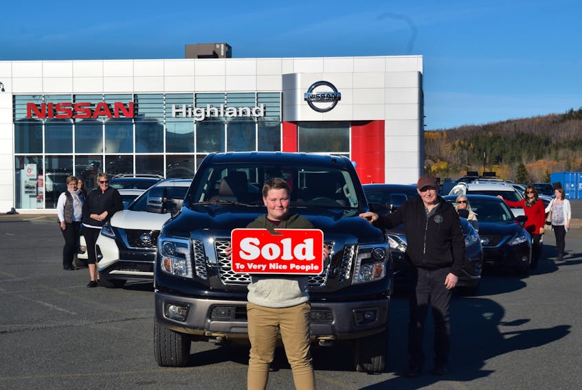 Standing in front of a fleet that he helped sell is young Cole Ross, 13, and student at East Pictou Middle School. Over the years Highland Nissan staff added up the revenue that Ross has helped bring in to roughly $300,000.