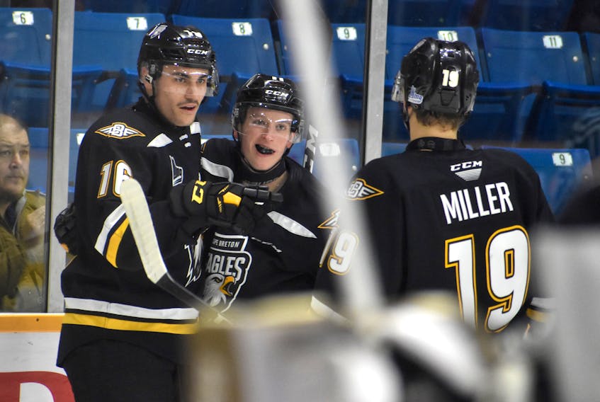 Derek Gentile of the Cape Breton Eagles, middle, celebrates his first of two goals in the game with teammates Shawn Element, left, and Shaun Miller during Quebec Major Junior Hockey League action at Centre 200 on Tuesday. Cape Breton won the game 4-0.