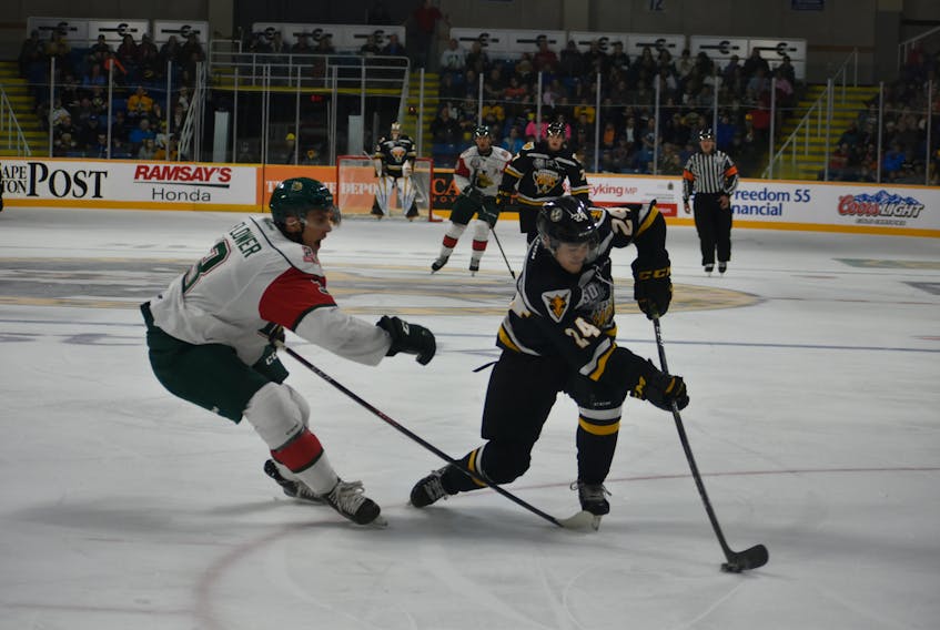 Ryan Francis, right, of the Cape Breton Screaming Eagles works his way around Walter Flower of the Halifax Mooseheads during Quebec Major Junior Hockey League action at Centre 200 on Friday. The game marked the Screaming Eagles' home-opener. Halifax won the game 4-2.