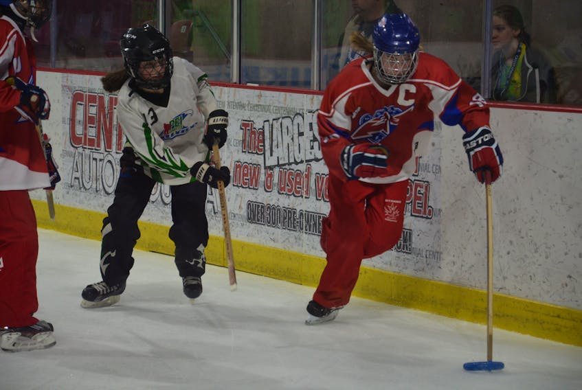 Callie Dawes of the Calgary Core controls the ring while being pursued by the P.E.I. Wave’s Emily Peters during the gold-medal game of the Under-16 Division of 2019 Credit Union Canadian ringette championships in Summerside on Saturday morning. Dawes scored a hat trick to lead Calgary to a 5-1 victory.
