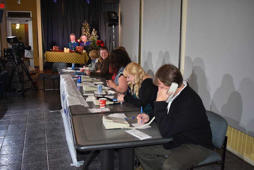 Volunteers answer phones during the annual Pictou County Christmas Fund Telethon at the deCoste Centre in Pictou.