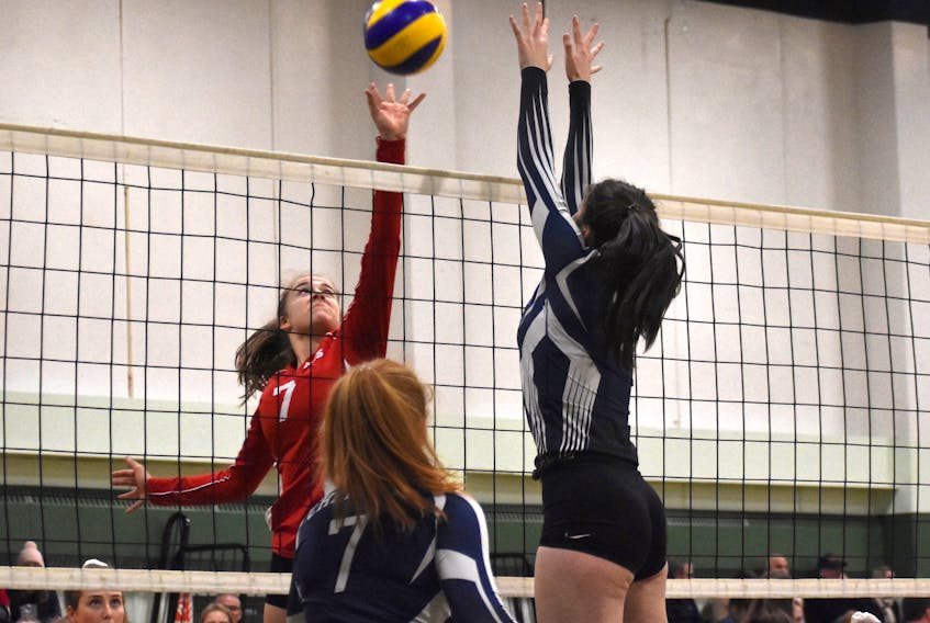 Madeleine LeVert of the Riverview Royals, left, tries to score as Christiane Verstege of the Charles P. Allen Cheetahs attempts to block it during Nova Scotia School Athletic Federation Division 1 girls' volleyball provincial championship action at Memorial High School in Sydney Mines on Friday. JEREMY FRASER/CAPE BRETON POST