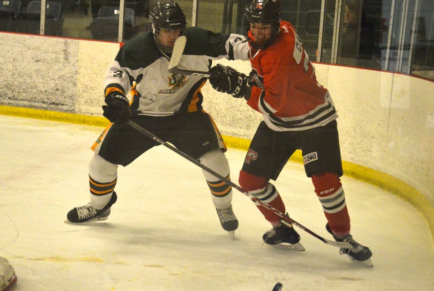 Tye Clarke of the Glace Bay Panthers, right, battles for the puck with Will Lawless of the Memorial Marauders during Cape Breton High School Hockey League semifinal action at the Emera Centre Northside in North Sydney on Thursday. Glace Bay won the game 7-0.
