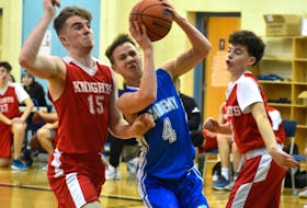 Adam Callaghan of the Sydney Academy Wildcats, middle, drives the lane as he's pressured by Millwood Knights players Morgan Rae, left, and Zach Duke during Governors Pub and Eatery Wildcat Invitational basketball tournament action at the Sydney Academy gym on Friday. Sydney Academy won the game 88-79