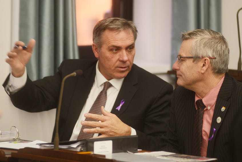 Health Minister Robert Mitchell, left, is shown with Agriculture and Fisheries Minister Robert Henderson prior to the start of question period Wednesday in the P.E.I. legislature.