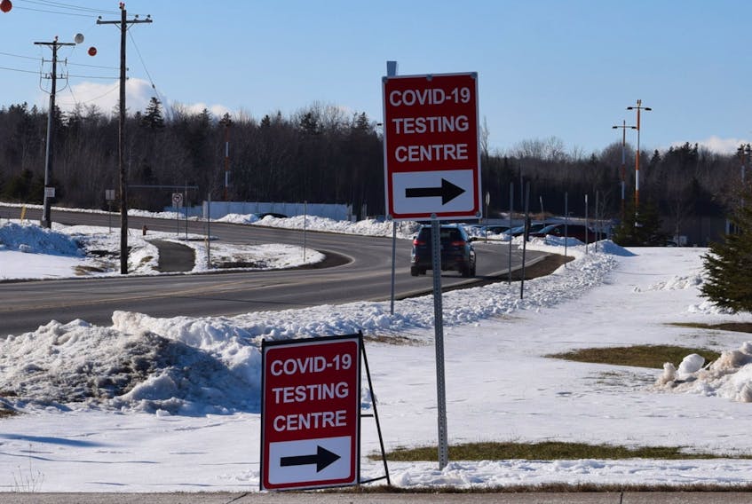 Directional signs for COVID testing near the Rath Eastlink Community Centre.