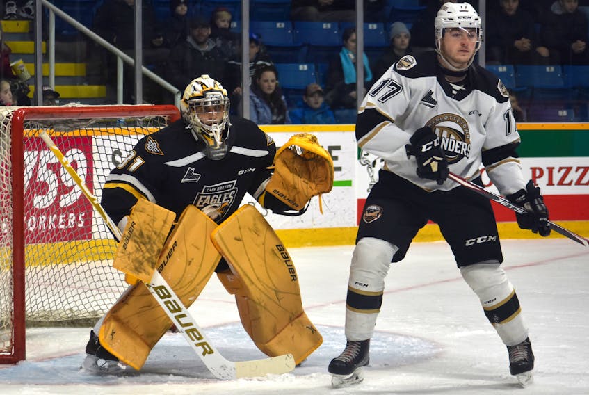 Kevin Mandolese of the Cape Breton Eagles, left, watches the play as Liam Peyton of the Charlottetown Islanders stands nearby during Quebec Major Junior Hockey League action at Centre 200 on Tuesday. Mandolese stopped all 32 shots he faced for his first shutout of the season to help guide Cape Breton to a 4-0 win.