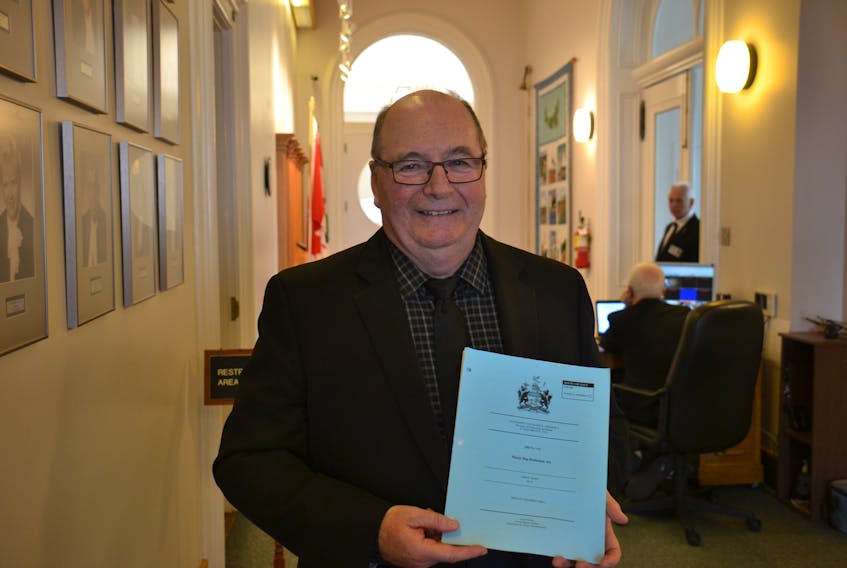 Montague-Kilmuir MLA Allen Roach holds a copy of the bill passed Friday that would ban single-use plastic bags. With its passing, the Island becomes the first province to legislate a ban on plastic bags.